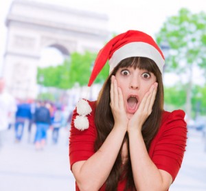 scared woman wearing a christmas hat against a street background